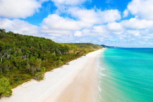 Aerial view of Queensland's Fraser Coast shoreline with pristine beaches and turquoise waters